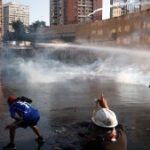 People are attacked with water and tear gas